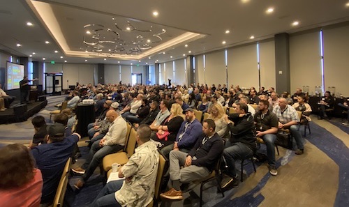 DSC20-generalsession AutoVitals' Employees listening to speaker.